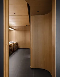 Modern restaurant featuring wooden paneling walls and ceiling