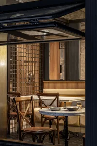 Industrial-themed restaurant interior with wood and concrete materials.