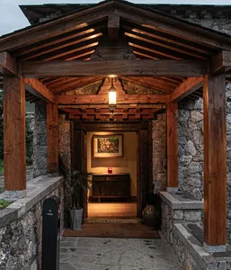 Entrance to a traditional-style building featuring wooden beams and stone walls.