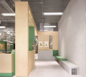 A minimalist office space featuring concrete, wood, and glass materials