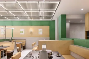 A modern restaurant interior featuring minimalist design with acrylic and wood materials.