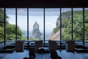 Hotel lobby with glass windows overlooking natural scenery and mountains