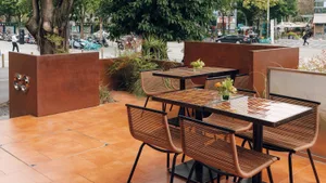 Outdoor cafe with metal composite furniture and planters