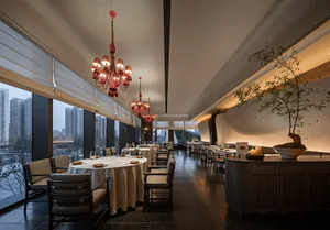 Modern luxury dining room with elegant furniture and a chandelier.