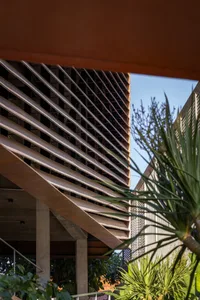 Modern metal architectural terrace with geometric design and green plants.