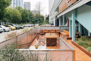 An outdoor cafe with modern design features, including concrete seating and tables.