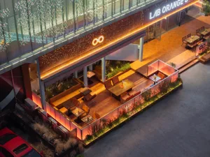 Outdoor seating area with wooden furniture in an urban setting.