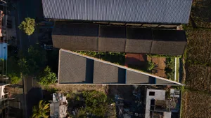 Aerial view of a modern building with a tiled roof.