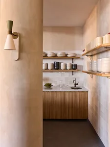 Minimalist kitchen featuring ceramic shelves and storage solutions.