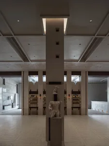 Modern hotel lobby featuring concrete and glass materials.