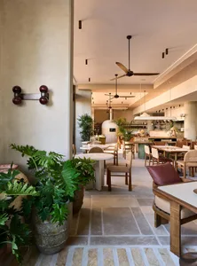 Modern restaurant interior with concrete and wooden features.