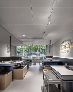 Modern restaurant interior with metallic tables and industrial design elements