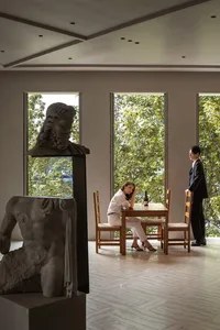 A modern dining room featuring sculptures in a contemporary setting.