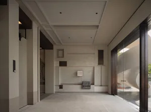 A modern interior space featuring concrete walls and glass elements.