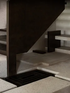 A modern interior featuring a concrete staircase with a black metal railing and minimalist design.