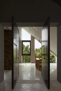 Modern living space featuring stone flooring without masonry features.
