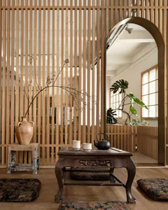 A minimalist living room featuring wooden furniture and a tea table with cups and kettle.