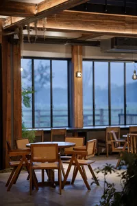 A modern restaurant interior featuring wooden furniture.