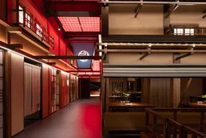 A modern restaurant interior with wooden elements and open spaces.
