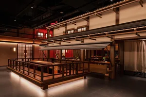 A traditional restaurant interior featuring wooden flooring and seating.