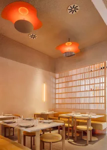 A minimalist restaurant interior with terrazzo flooring and ceiling lights.