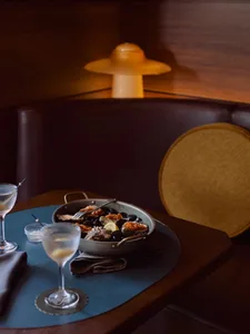 Modern restaurant interior featuring dark walnut wood furniture and a cozy ambiance