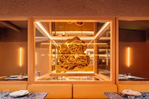 Modern restaurant interior with a metallic, futuristic design element