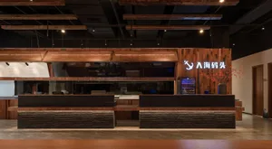 An industrial-style retail store interior featuring wooden accents, glass countertops, and metallic fixtures.