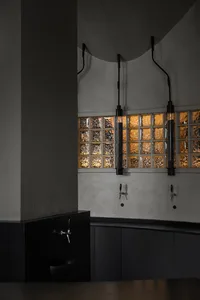 Industrial-style bar area with glass feature tiles and pendant lights