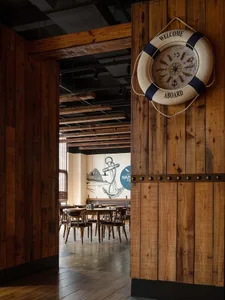 A wooden restaurant interior with a nautical theme.