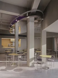A spacious, industrial-style restaurant interior featuring concrete flooring, high ceilings, and modern lighting fixtures.