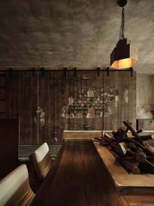 A cozy restaurant interior with rustic wooden walls, a fire pit, and traditional Chinese painting