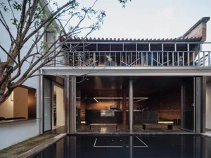 A modern residential kitchen featuring metal and glass materials.