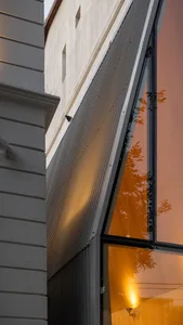 Modern office building with glass exterior and metallic accents.