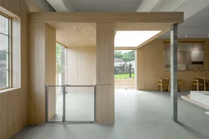 View of a minimalist restaurant interior with wooden walls and flooring