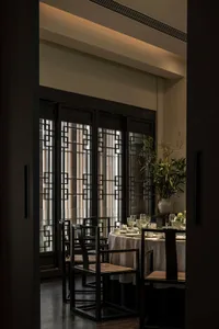 Industrial-style restaurant interior with metal frame chairs and tables.