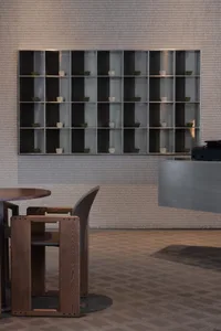 Modern restaurant interior featuring wooden tables and concrete walls.