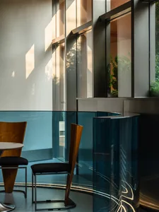 Interior of a modern cafe with glass walls and modern furniture.