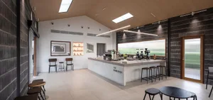 Modern coffee shop interior featuring a concrete counter and seating area