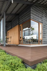 Modern exterior architectural design featuring wooden accents, steel framing, and concrete materials.