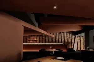 A modern restaurant interior featuring brick and wooden elements.
