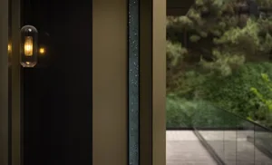 Modern staircase with glass railing and concrete steps and wall