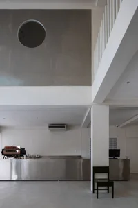 Modern minimalist coffee shop interior with steel counter and concrete accents