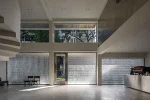 Modern coffee shop interior with glass block walls and concrete flooring.