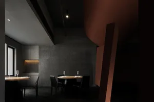 A modern restaurant interior with black concrete walls and metal accents