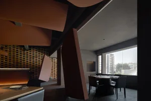 Modern restaurant interior with black and orange metallic accents