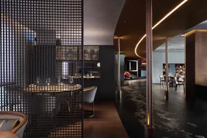 Modern restaurant interior featuring black metal mesh partitions and contemporary design.