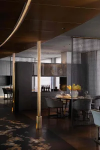 A contemporary restaurant interior with metal, glass, and wooden elements.