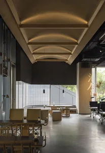Industrial-themed restaurant interior with concrete and wooden elements.