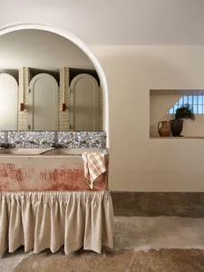 Interior design featuring minimalist bathroom with concrete sink and terrazzo backsplash